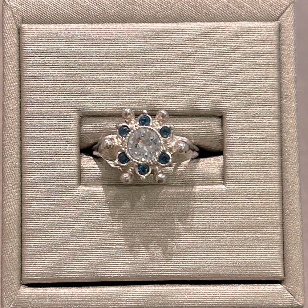 AVON silver ring with blue and white stones, never worn.